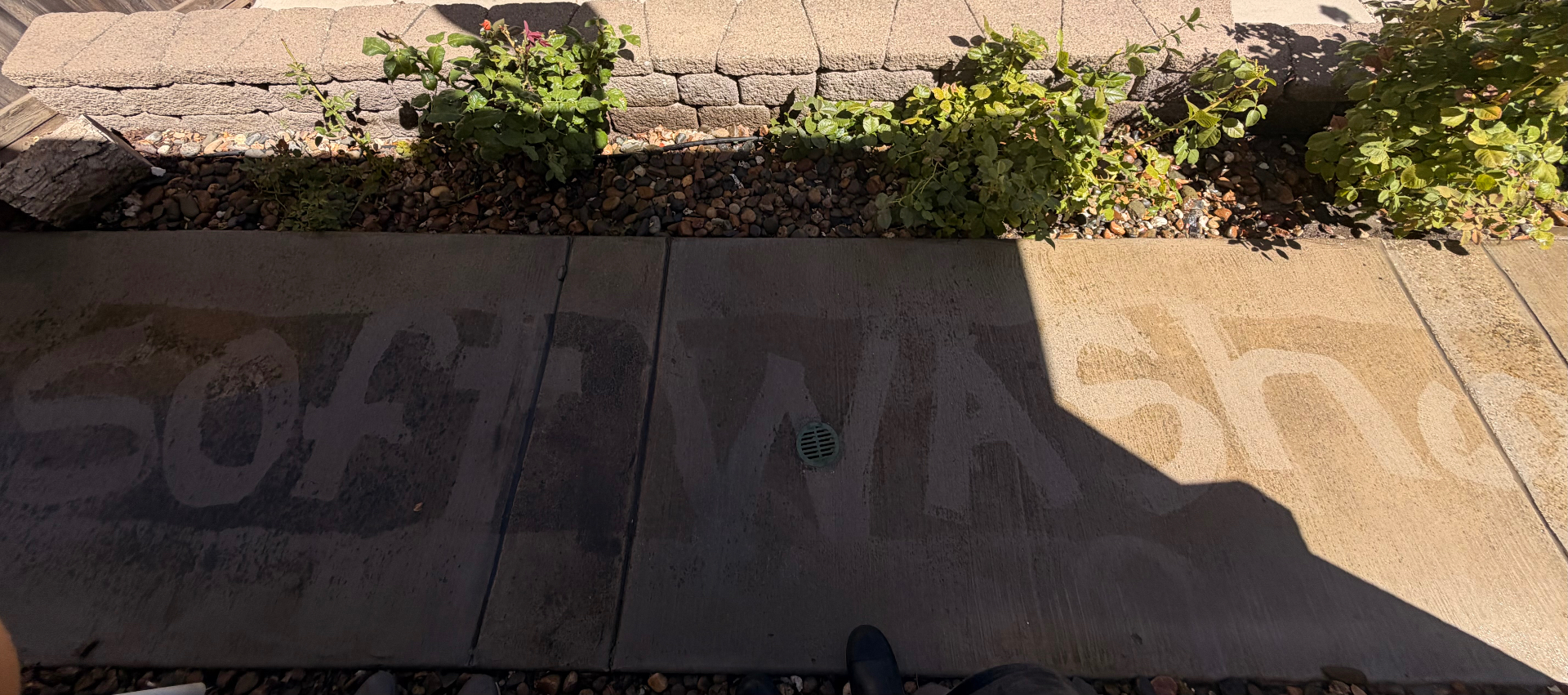 Soft Wash Co. driveway cleaning in progress — before and after in one shot